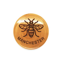 Load image into Gallery viewer, Circular olive wood magnet with bee and MANCHESTER lasered on