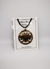 Load image into Gallery viewer, Manchester bee olive wood necklace, made in Bethlehem. Hung on black cord and in packaging