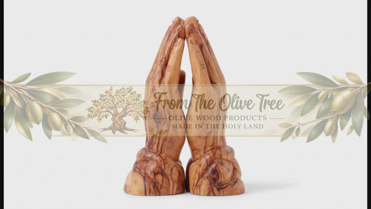 Wooden sculpture of hands in a praying position on a white background. PRAYING HANDS.