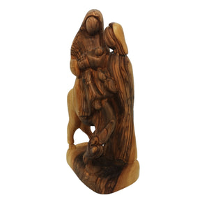 side of Hand carved olive wood statue made in Bethlehem. The flight to Egypt, Mary and Jesus on donkey, Joseph standing next to them