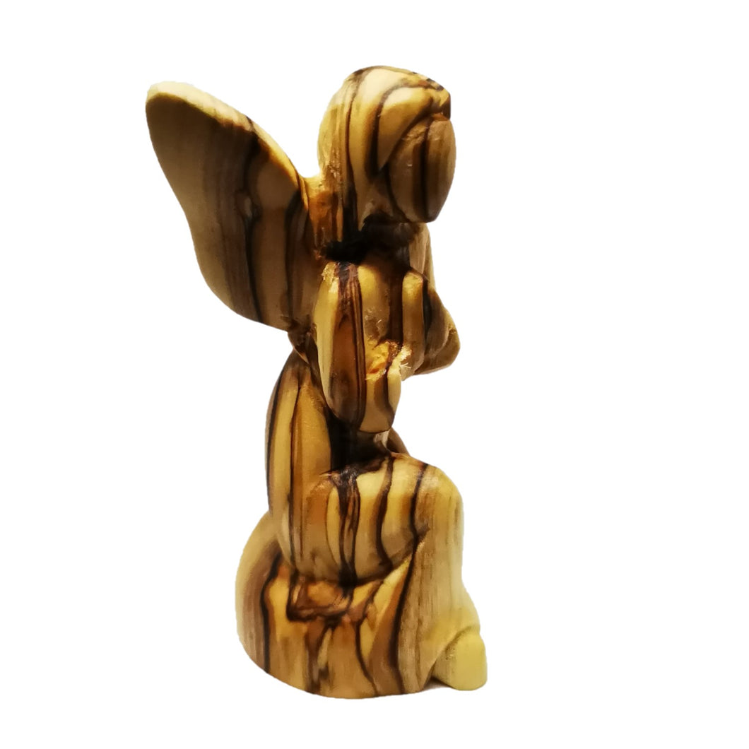 side view of Hand carved olive wood angel made in Bethlehem, unique grain